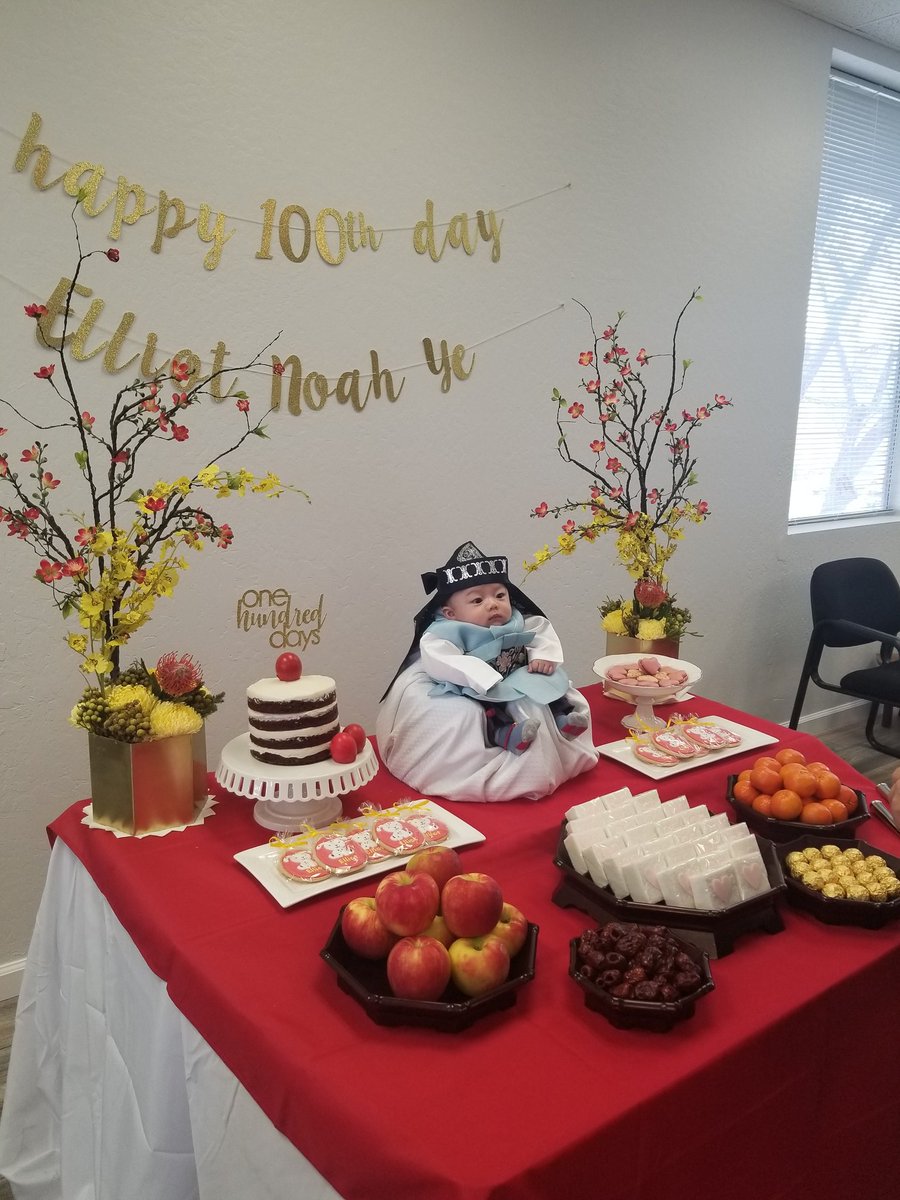100 day party baby posed like a tiny emperor